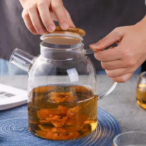 Clear glass teapot with wooden lid, heat resistant flowering tea pot for daily kitchen use.