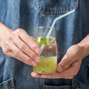 Clear glass cold water bottle and juice beverage bottle with stylish design for home daily use.