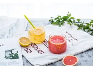 Detailed shot of clear heat-resistant glass cup with handle and cute sun design for drinks.
