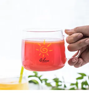 Detailed close-up shot of the transparent heat-resistant glass cup with handle and sun print.