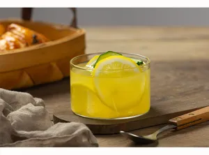 Glass dessert bowl detail view, high temperature resistant clear cup showcasing food presentation.