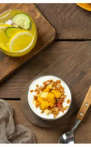 Glass dessert bowl detail, clear glass yogurt cup close up view on rustic wooden background.