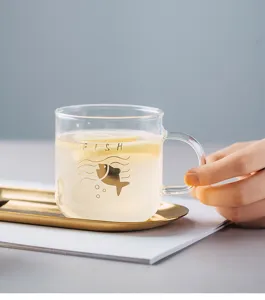Heat-resistant glass mug with gold fish print and handle, perfect for coffee, tea and juice.