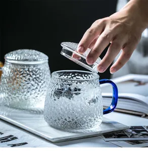 Japanese hammered glass tea cup with blue handle and lid, simple style detail view.