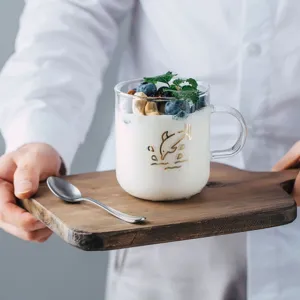 Clear glass cup with handle, heat resistant coffee and tea mug with cute dolphin design for home use.
