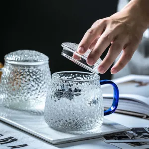 Japanese hammered glass mug with lid and blue handle, clear tea cup for home use main view.