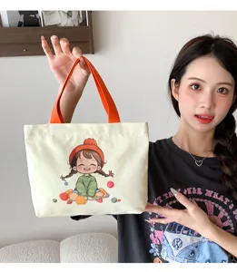 Piccola borsa in tela da donna, shopper stampata con simpatico disegno e manici arancioni.
