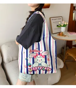Detailed view of the cute striped canvas tote bag with rabbit print, lifestyle scene.