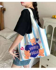Detail view of cute cartoon bear canvas tote bag featuring sweet graphic design style.
