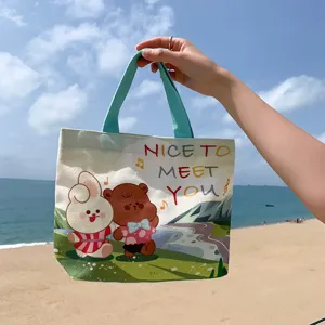 Mini canvas handbag for women, cute cartoon bear and rabbit print, casual tote bag for daily commute.