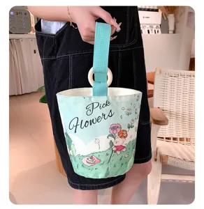 Detailed view of the cute canvas bucket bag with floral bear print and wooden ring handle.