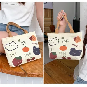 Cartoon canvas tote bag for women, cute graphic handbag with zipper and sturdy handles.