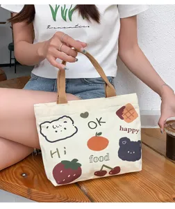 Cute cartoon canvas tote bag detail view, featuring lovely bear and fruit prints with zipper.