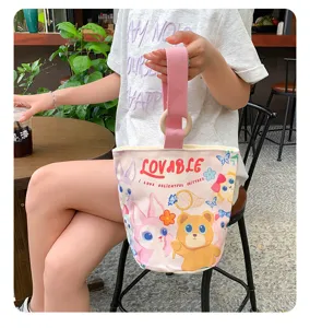 Canvas bucket bag for women, casual tote handbag with cute cartoon print and wooden ring handle.