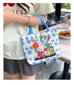 Mini canvas tote bag for women, cute cartoon print daily commuting bento handbag detail view.