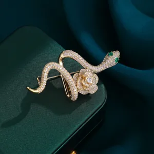 Exquisite snake and rose brooch detail, gold-plated micro-pavé zirconia with green crystal eyes.
