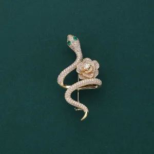 Elegant rhinestone snake and rose brooch pin, vintage gold-tone fashion jewelry for women.