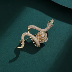Detail view of a vintage-style full rhinestone green snake and rose flower brooch pin