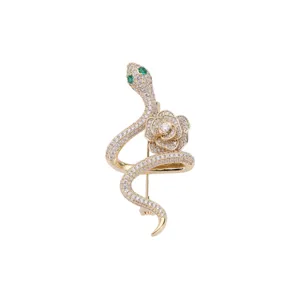 Exquisite gold-plated snake and camellia brooch, sparkling cubic zirconia with green crystal eyes.