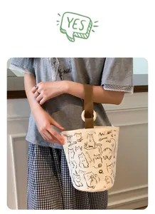 Dettaglio borsa secchiello in tela di gatto cartone animato, borsa a mano casual con manico.