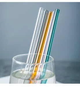 Detailed close-up shot of colorful glass drinking straws placed in a clear water cup.