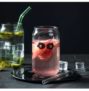 Clear glass cup with straw and cute cartoon print, ideal for water, juice, and iced beverages.