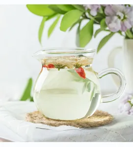 Hitzebeständige Teekanne Detailansicht aus klarem Glas mit Kräuteraufguss im hellen Stil.