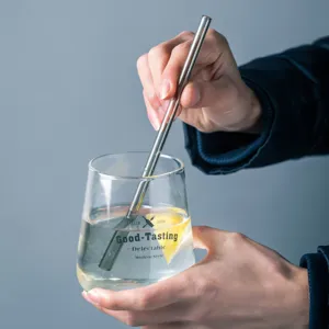 Transparent glass cup with glass straw for juice and beverages, modern stylish drinking glassware.