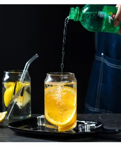 Clear glass can cup for cold drinks, iced juice, lemonade, and refreshing summer beverages.
