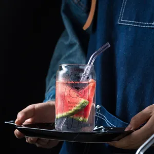 Transparent glass cola cup with straw and cute print, perfect for refreshing juices and drinks.