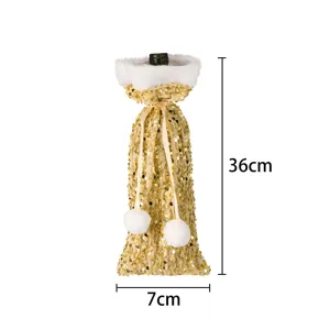 Christmas gold sequin wine bottle cover with white plush trim and pom-poms for table decor.
