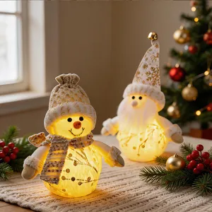 Nordic glowing plush snowman and Santa Claus ornaments with warm night light details.