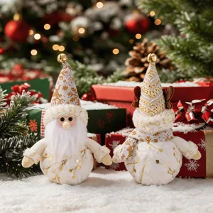 Close up of Nordic plush Santa and reindeer Christmas ornaments with gold bell and festive decor.