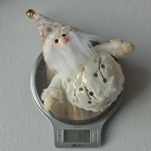 Nordic plush Santa Claus figurine Christmas gnome ornament with glowing light for desktop decor.
