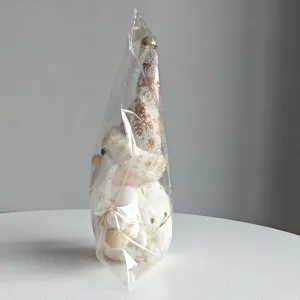 Nordic plush Santa gnome ornament detail view, soft toy holiday decor in transparent packaging.