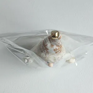 Nordic plush snowman Christmas ornament detail, cute knitted hat with gold bell, festive decor.