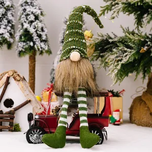 Christmas gnome doll with dangling legs and knit hat sitting on vintage red car decor.