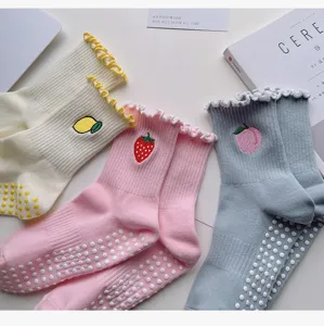 Close-up detail of women non-slip yoga socks with cute fruit embroidery and anti-slip silicone soles.