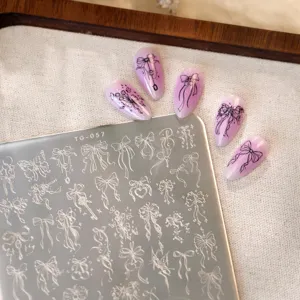 Premium nail art stamping plate with intricate bow patterns and matching lilac nails
