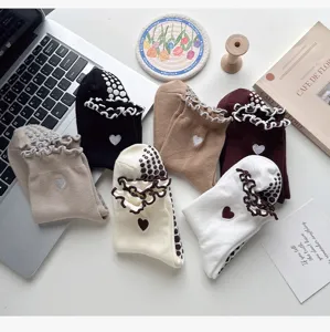 Non-slip grip yoga socks with cute ruffle and heart embroidery for pilates and fitness workouts.