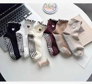 Non-slip grip yoga socks with cute heart embroidery and ruffle cuffs, perfect for pilates.