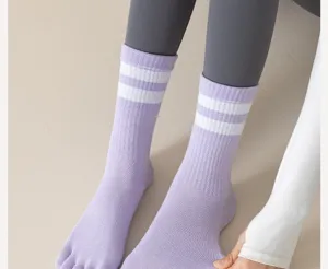 Close-up detail of women's purple five toe socks with white double stripes mid-calf fit.