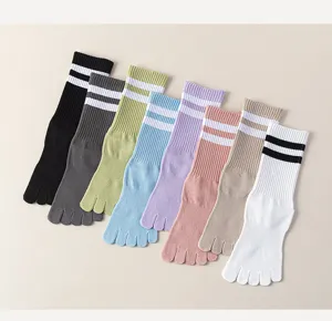Close-up detail of colorful striped mid-calf five finger socks, soft cotton split toe design.