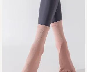 Detailed view of women's yoga toe socks, non-slip cotton mid-calf socks for fitness pilates.