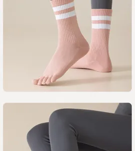 Detail view of women pink mid-tube five toe socks with white stripes for yoga and sports running.