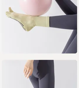 Women's cotton five toe non slip yoga socks, mid calf split toe design for pilates fitness.