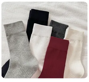 Detailed view of women solid color ribbed mid tube cotton socks, casual autumn long socks.