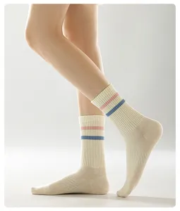 Close-up detail shot of women's cotton mid-calf socks featuring pink and blue stripes.
