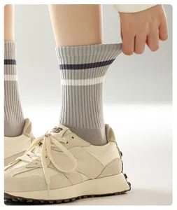 Cotton mid-tube socks for women, breathable striped casual athletic sports socks.