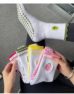 Non-slip yoga socks with cute fruit embroidery, breathable fabric, and secure grip dots.